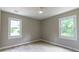 Bedroom with ceiling fan, wood-look floors, and two windows at 788 Fayetteville Se Rd, Atlanta, GA 30316