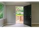 Welcoming entryway featuring a black front door, light-filled sidelight window, and outdoor deck view at 788 Fayetteville Se Rd, Atlanta, GA 30316