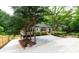 Eye-level view of home with a gravel driveway and manicured landscaping, featuring a charming front entrance at 788 Fayetteville Se Rd, Atlanta, GA 30316