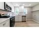 Modern, well-lit kitchen featuring stainless steel appliances and white cabinets at 788 Fayetteville Se Rd, Atlanta, GA 30316