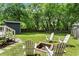 Private backyard with a fire pit, Adirondack chairs, and a lush green lawn at 2647 Forrest Nw Ave, Atlanta, GA 30318