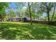 Expansive backyard featuring lush greenery, a shed, and a well-maintained lawn, providing a serene outdoor space at 2647 Forrest Nw Ave, Atlanta, GA 30318