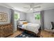 Cozy bedroom features hardwood floors, light gray walls, and two windows with natural light at 2647 Forrest Nw Ave, Atlanta, GA 30318