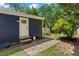Exterior view with a walkway leading to a charming house entrance, accented by tasteful landscaping at 2647 Forrest Nw Ave, Atlanta, GA 30318