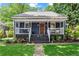 Charming home featuring a welcoming front porch, wood door, landscaped front yard, and fresh curb appeal at 2647 Forrest Nw Ave, Atlanta, GA 30318