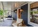 Relaxing front porch with seating, wood door, charming exterior lighting, and serene neighborhood views at 2647 Forrest Nw Ave, Atlanta, GA 30318