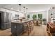 Bright kitchen with stainless steel appliances, a center island, and an adjacent dining area at 2647 Forrest Nw Ave, Atlanta, GA 30318