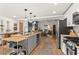 Open-concept kitchen flows into living space, featuring stainless steel appliances, granite countertops, and modern lighting at 2647 Forrest Nw Ave, Atlanta, GA 30318