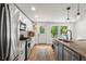 Bright kitchen features stainless steel appliances, granite countertops, and modern lighting fixtures at 2647 Forrest Nw Ave, Atlanta, GA 30318