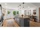 Modern kitchen featuring granite countertops, stainless steel appliances, stylish pendant lights, and a center island at 2647 Forrest Nw Ave, Atlanta, GA 30318