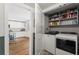 A laundry room includes a side-by-side washer and dryer, along with shelving for storage at 2647 Forrest Nw Ave, Atlanta, GA 30318