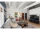 Stylish living room with exposed beam ceilings, modern decor, ample seating, and plenty of natural light at 2647 Forrest Nw Ave, Atlanta, GA 30318