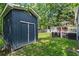 A shed and outdoor deck area with an umbrella and table, creating a cozy and functional backyard space at 2647 Forrest Nw Ave, Atlanta, GA 30318