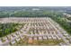 Areal view of Loganville, GA, highlighting a neighborhood with similar single-Gathering homes near a pond at 3828 Ramsay Pass, Loganville, GA 30052