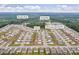 Overhead view of Loganville neighborhood featuring uniform houses, ample green space, and community amenities, emphasizing planned living at 3828 Ramsay Pass, Loganville, GA 30052