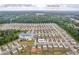Sprawling neighborhood in Loganville, GA, showcasing the layout of homes and community spaces with lush greenery and blue skies at 3828 Ramsay Pass, Loganville, GA 30052