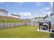 Expansive backyard area with green grass, privacy fence, and outdoor gazebo with a dining set at 3828 Ramsay Pass, Loganville, GA 30052