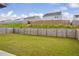 Large backyard featuring a well-maintained lawn and a wood privacy fence at 3828 Ramsay Pass, Loganville, GA 30052