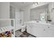 Well-lit bathroom featuring a tub-shower combination and a white vanity at 3828 Ramsay Pass, Loganville, GA 30052