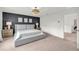 This primary bedroom boasts an accent wall and large windows to bring in natural light at 3828 Ramsay Pass, Loganville, GA 30052