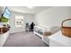 This bedroom features a TV, computer, and white crib, perfect for a room at 3828 Ramsay Pass, Loganville, GA 30052