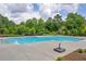 Large community pool surrounded by a spacious deck and lush greenery at 3828 Ramsay Pass, Loganville, GA 30052