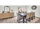 Dining area with seating for eight, modern decor, and seamless access to the outdoor space at 3828 Ramsay Pass, Loganville, GA 30052