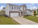Beautiful two-story home featuring brick accents, a well-maintained lawn, and a spacious driveway at 3828 Ramsay Pass, Loganville, GA 30052