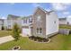 Two-story home with brick and siding exterior, attached garage, and well-maintained lawn at 3828 Ramsay Pass, Loganville, GA 30052