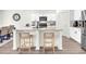 Kitchen island with granite countertops, seating and stainless steel appliances at 3828 Ramsay Pass, Loganville, GA 30052