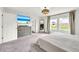 The primary bedroom boasts lots of natural light with neutral, modern decor and a TV at 3828 Ramsay Pass, Loganville, GA 30052