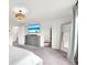This well-lit primary bedroom features a large dresser, closet, mirror, and a mounted TV at 3828 Ramsay Pass, Loganville, GA 30052
