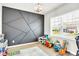 Bright playroom featuring a fun geometric accent wall and a variety of toys at 3828 Ramsay Pass, Loganville, GA 30052