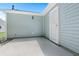 A concrete back patio with a white door on a light green home at 5805 Eagles Feather Ln, Riverdale, GA 30274