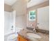 Granite vanity in a bathroom with shower and neutral wall paint at 5805 Eagles Feather Ln, Riverdale, GA 30274