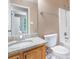 Bathroom with granite vanity, toilet, window, and tub with shower at 5805 Eagles Feather Ln, Riverdale, GA 30274