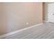 Neutral bedroom features laminate flooring, a door, and blank walls at 5805 Eagles Feather Ln, Riverdale, GA 30274