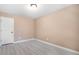 A bedroom with neutral walls and wood-look flooring at 5805 Eagles Feather Ln, Riverdale, GA 30274