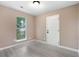 Bedroom features window, neutral wall paint, white door, and laminate flooring at 5805 Eagles Feather Ln, Riverdale, GA 30274