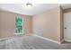 Neutral bedroom has vinyl flooring and a window letting in natural light at 5805 Eagles Feather Ln, Riverdale, GA 30274