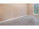 Bright bedroom with laminate flooring, neutral paint, and a window view at 5805 Eagles Feather Ln, Riverdale, GA 30274