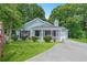 Charming single-story home with manicured lawn, white picket fence, and inviting entryway at 5805 Eagles Feather Ln, Riverdale, GA 30274