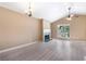 Bright living room features a fireplace, ceiling fan, chandelier, and large window at 5805 Eagles Feather Ln, Riverdale, GA 30274