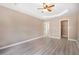 Main bedroom features laminate flooring, neutral wall paint, tray ceiling, and ceiling fan at 5805 Eagles Feather Ln, Riverdale, GA 30274