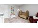 Well-decorated Bedroom with a wooden crib, soft rug, and cozy reading chair at 720 Mountain Laurel Dr, Canton, GA 30114