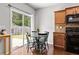 Bright dining area with a view of the backyard and featuring dark wood cabinets and table at 720 Mountain Laurel Dr, Canton, GA 30114