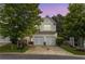 Charming townhome featuring a two-car garage, neutral siding, and professionally maintained landscaping at 720 Mountain Laurel Dr, Canton, GA 30114