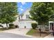 Charming two-story home with a two-car garage, well-manicured lawn, and mature trees at 720 Mountain Laurel Dr, Canton, GA 30114