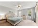 Spacious main bedroom with a ceiling fan, carpeted floors, and windows for plenty of light at 720 Mountain Laurel Dr, Canton, GA 30114