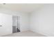 Bright bedroom featuring neutral carpet and paint, adjacent to another room through an open white door at 116 Chattahoochee Cir, Locust Grove, GA 30248
